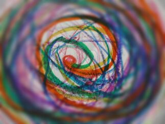 Swirling colors in crayon and marker: red, orange, blue, green and purple with barely visible white paper as the background.