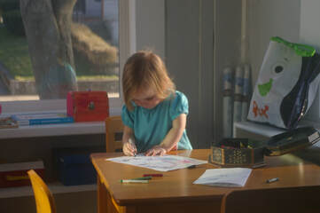 Child drawing and being artistic on paper.